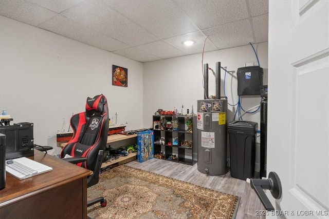 office space featuring wood finished floors, water heater, and a drop ceiling
