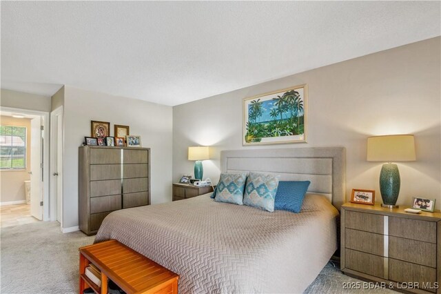 carpeted bedroom featuring baseboards