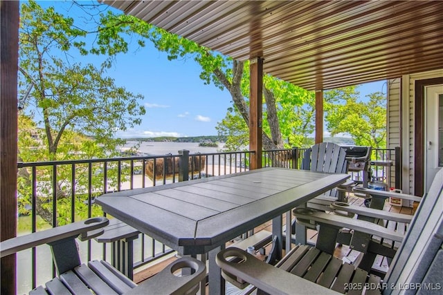 exterior space featuring outdoor dining space and a water view