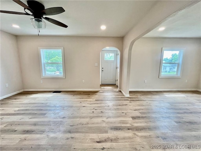 407 Cleveland St, Versailles, MO 65084 - entrance foyer featuring baseboards, arched walkways, and wood finished floors