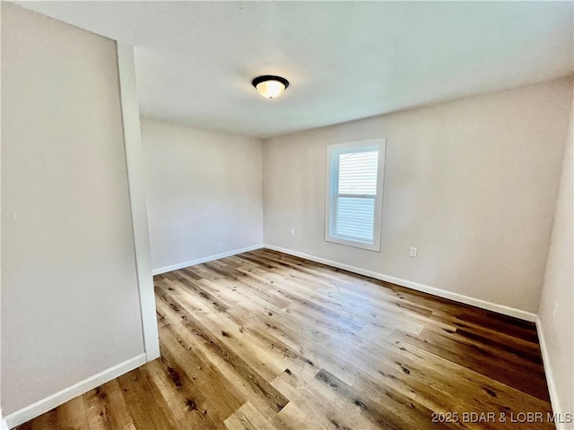 407 Cleveland St, Versailles, MO 65084 - spare room featuring baseboards and wood finished floors