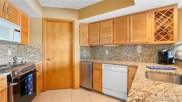 32 Cedar Ct Unit 3A, Lake Ozark, MO 65049 - kitchen with decorative backsplash, white appliances, light stone countertops, a sink, and light tile patterned floors