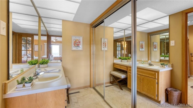 32 Cedar Ct Unit 3A, Lake Ozark, MO 65049 - full bathroom featuring a sink, visible vents, a ceiling fan, and two vanities