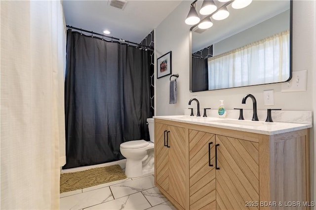 bathroom featuring visible vents, a sink, marble finish floor, and toilet