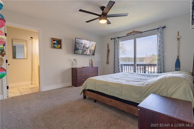 carpeted bedroom featuring baseboards, a ceiling fan, and access to exterior