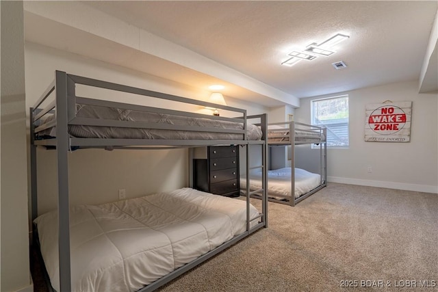 carpeted bedroom with visible vents and baseboards