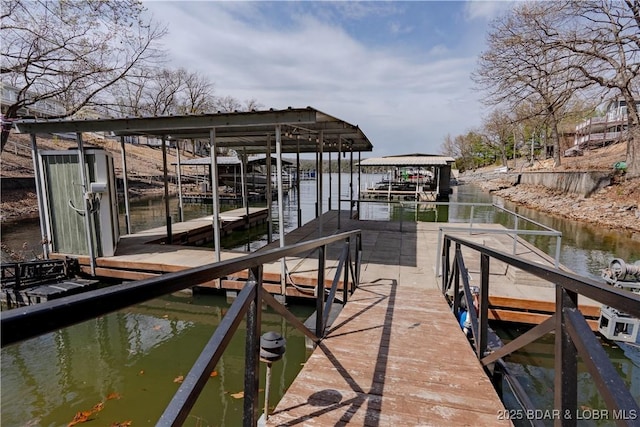 dock area featuring boat lift and a water view