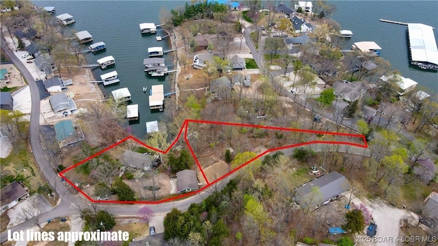 birds eye view of property with a water view and a residential view