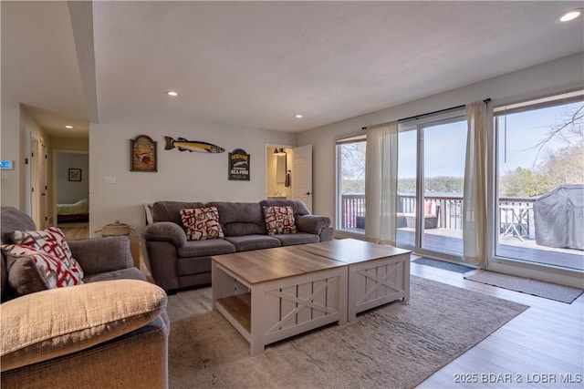 living area with recessed lighting and light wood-style flooring