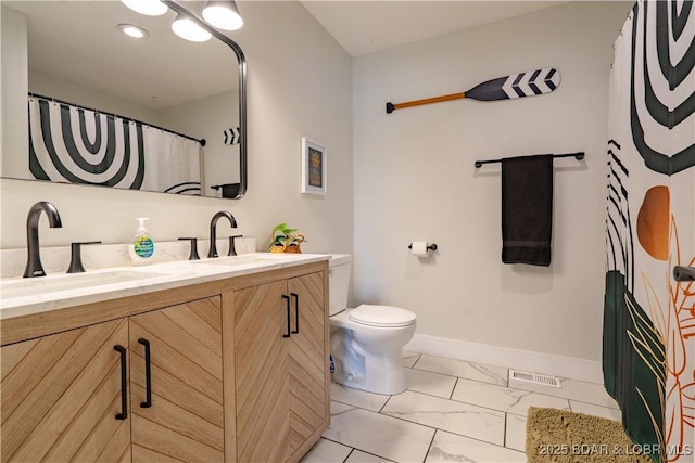 full bath featuring double vanity, a sink, marble finish floor, and toilet