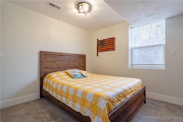 carpeted bedroom featuring baseboards and visible vents