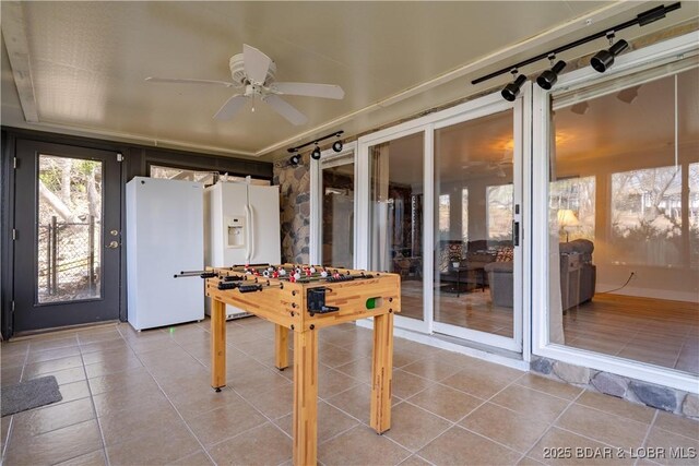 game room featuring rail lighting, ceiling fan, and light tile patterned flooring