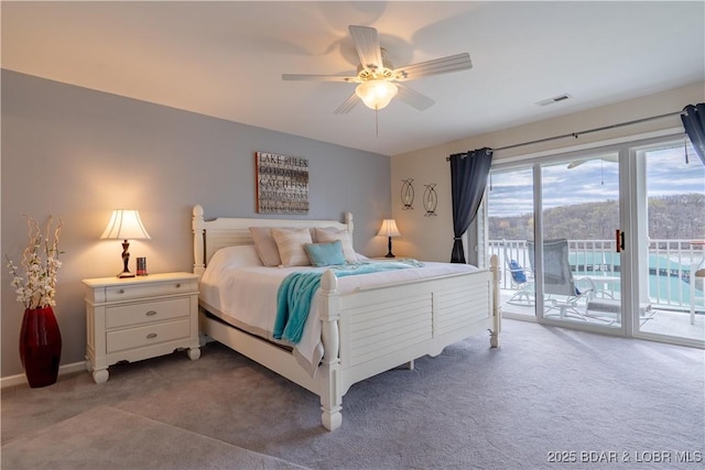 carpeted bedroom with visible vents, a ceiling fan, baseboards, and access to exterior