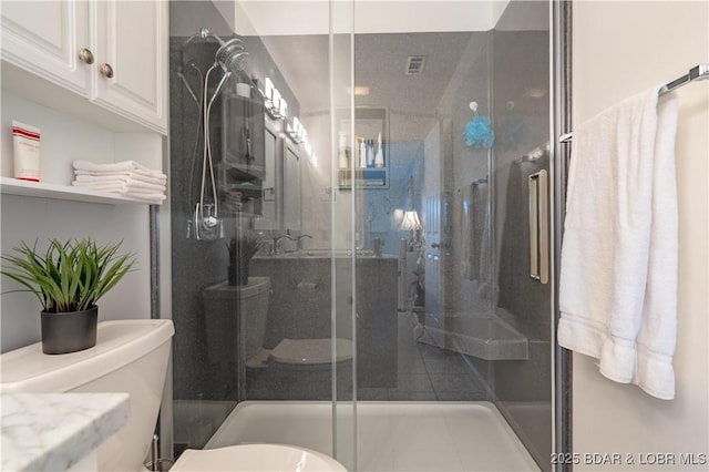 full bath with visible vents, toilet, and a shower stall