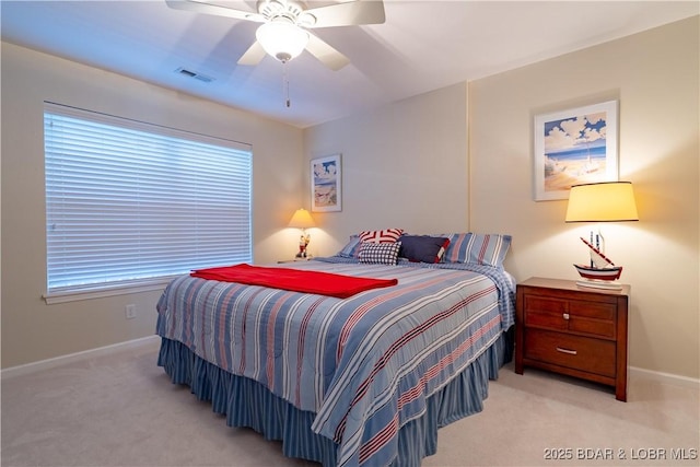 bedroom featuring baseboards, visible vents, light carpet, and ceiling fan