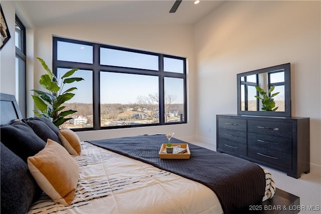 carpeted bedroom featuring baseboards, high vaulted ceiling, and multiple windows