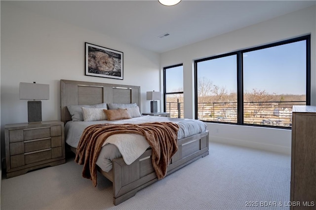 carpeted bedroom featuring visible vents and baseboards
