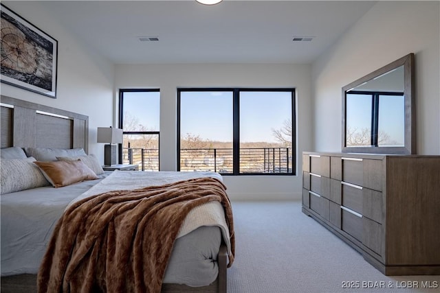 bedroom featuring visible vents, baseboards, and light carpet