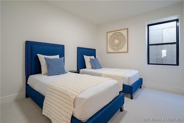 carpeted bedroom featuring baseboards