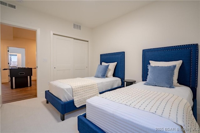 bedroom featuring visible vents, carpet, and a closet