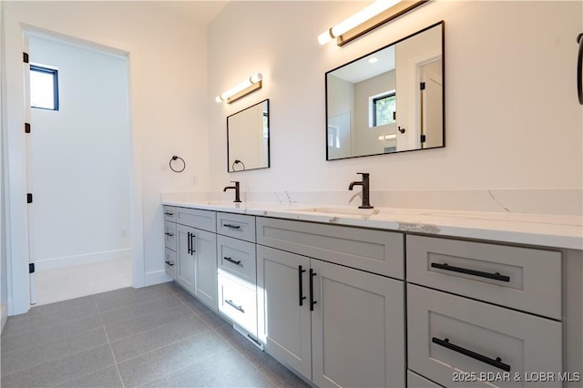 1152 Normandy Rd, Osage Beach, MO 65065 - bathroom with double vanity, baseboards, and tile patterned floors