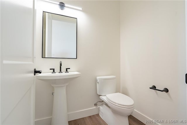 1152 Normandy Rd, Osage Beach, MO 65065 - half bathroom featuring baseboards, toilet, and wood finished floors
