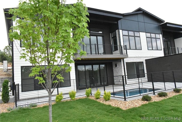1152 Normandy Rd, Osage Beach, MO 65065 - rear view of house featuring a balcony, a yard, and a patio area