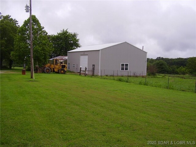 3521 S 240th Rd, Mo, MO 65685 - view of yard with a detached garage, fence, and an outbuilding