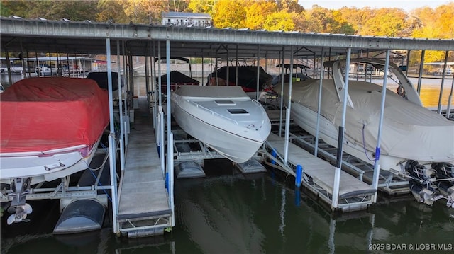 288 Windsor Bay Dr Unit 4B, Camdenton, MO 65020 - dock with boat lift, a water view, and a wooded view
