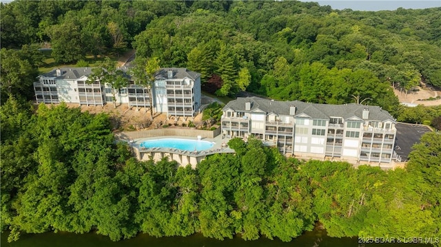 288 Windsor Bay Dr Unit 4B, Camdenton, MO 65020 - drone / aerial view of a heavily wooded area, a pool, and a large body of water