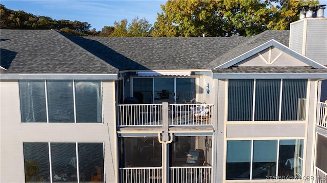 288 Windsor Bay Dr Unit 4B, Camdenton, MO 65020 - back of house featuring a shingled roof, a chimney, and a balcony