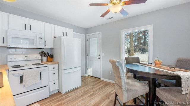 298 Storm Cove Dr, Linn Creek, MO 65052 - kitchen featuring ceiling fan, visible vents, white cabinets, light wood-style floors, and white appliances