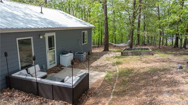 298 Storm Cove Dr, Linn Creek, MO 65052 - view of yard featuring central air condition unit, an outdoor hangout area, and a vegetable garden