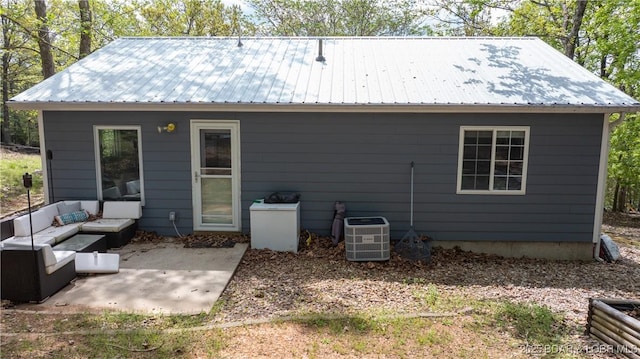 298 Storm Cove Dr, Linn Creek, MO 65052 - back of house featuring central AC unit, an outdoor living space, a patio area, and metal roof