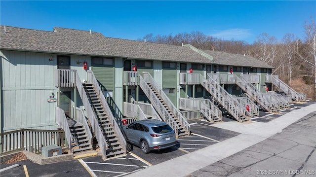 149 Southwood Shores Pl Unit 1B, Lake Ozark, MO 65049 - view of property featuring uncovered parking and stairway
