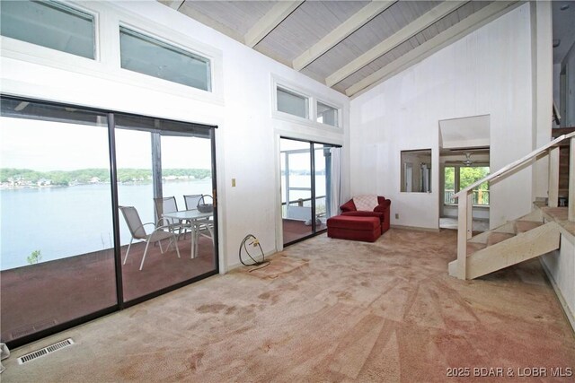 1483 Bluff Dr, Osage Beach, MO 65065 - interior space featuring visible vents, stairs, high vaulted ceiling, a water view, and carpet