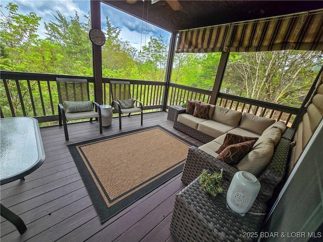 deck featuring an outdoor living space and ceiling fan