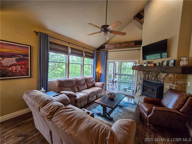 living room with baseboards, ceiling fan, wood finished floors, and a fireplace