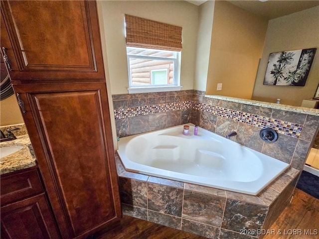 bathroom featuring wood finished floors and a garden tub