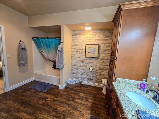 bathroom featuring wood finished floors, baseboards, vanity, toilet, and shower / tub combo with curtain