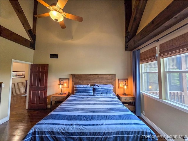 bedroom featuring baseboards, high vaulted ceiling, wood finished floors, and beam ceiling
