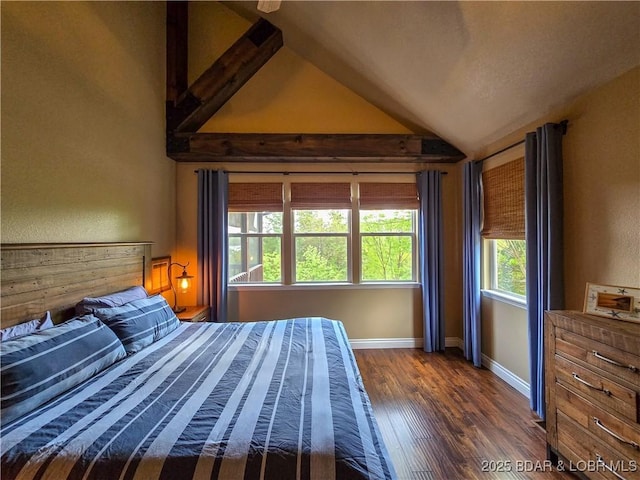 bedroom featuring baseboards, vaulted ceiling, and dark wood-style floors