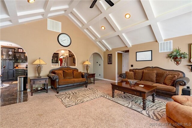 106 Bayliner Dr, Sunrise Beach, MO 65079 - living area featuring arched walkways, carpet flooring, beam ceiling, and visible vents