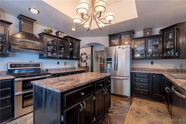 106 Bayliner Dr, Sunrise Beach, MO 65079 - kitchen with a center island, pendant lighting, arched walkways, appliances with stainless steel finishes, and premium range hood