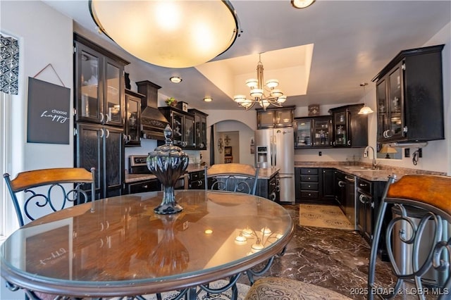 106 Bayliner Dr, Sunrise Beach, MO 65079 - dining space with an inviting chandelier and arched walkways