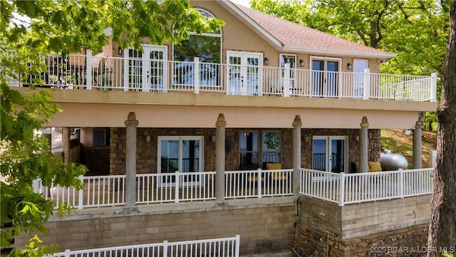 106 Bayliner Dr, Sunrise Beach, MO 65079 - back of property featuring a balcony, stone siding, and roof with shingles
