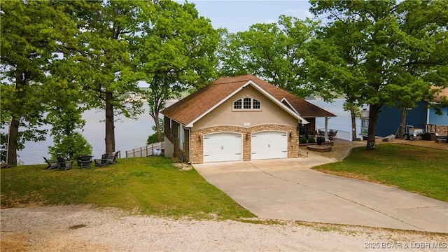 106 Bayliner Dr, Sunrise Beach, MO 65079 - view of front of property featuring an attached garage, stone siding, stucco siding, concrete driveway, and a front lawn