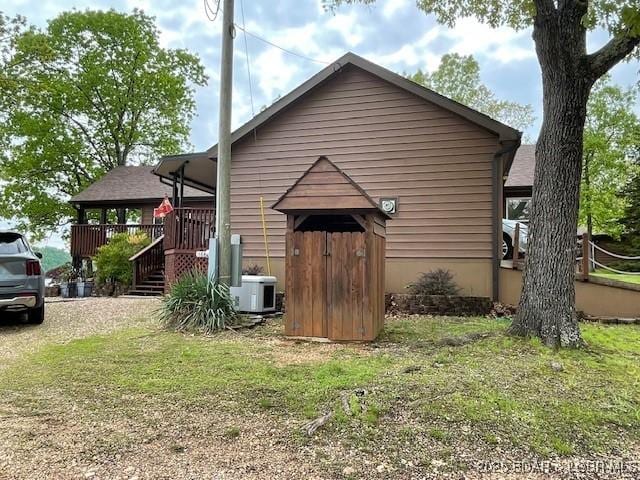 back of property featuring central air condition unit and a yard