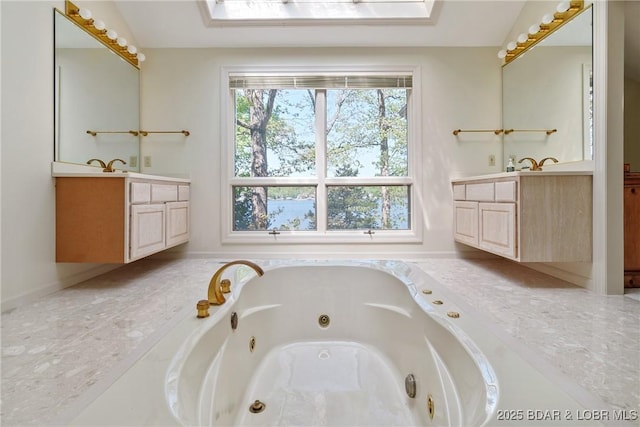 full bath featuring a jetted tub and two vanities