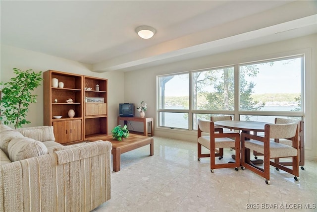 living area with beamed ceiling